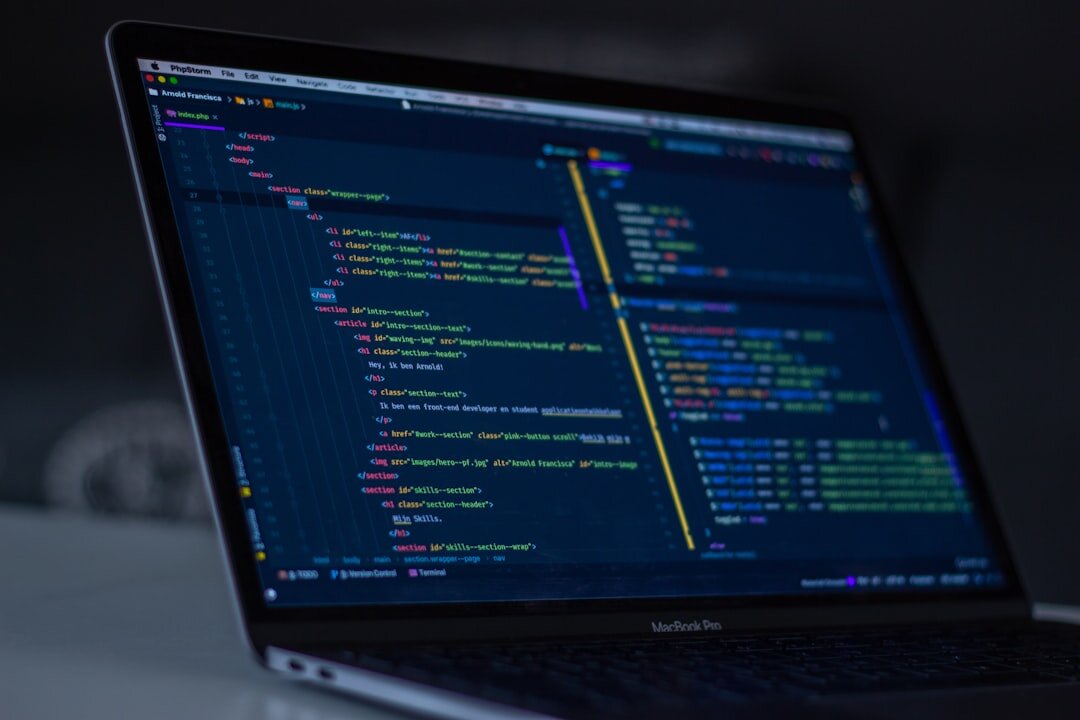 Software code on computer monitor in dark environment