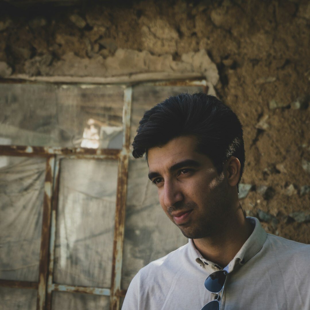 Young Turkish tech professional with glasses and casual outfit